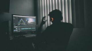 Creator editing video at a desktop workstation