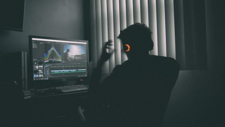 Creator editing video at a desktop workstation